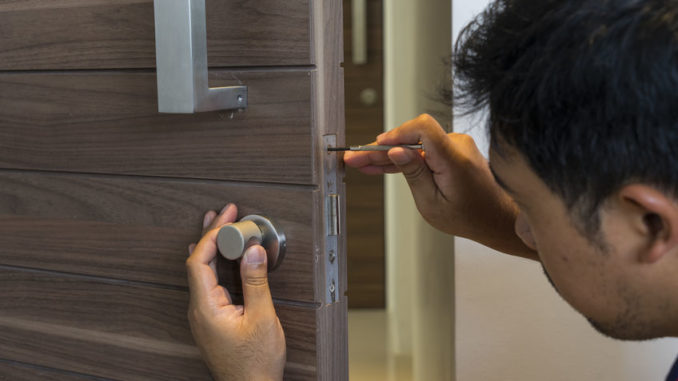 locksmith man fix the bathroom door by screwsriver